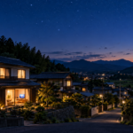 星空の見える町と暖かな窓明かりのある夜の住まい